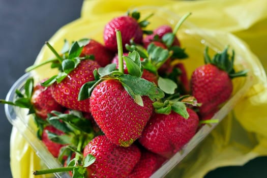 a hand is holding a strawberry,close-up close-up of a strawberry in hand