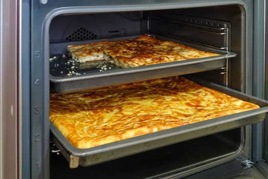 Turkish style water pastry baked in the oven, a tray full of pastries,