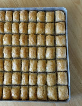 Famous Turkish baklava dessert sliced in a baking tray, Gaziantep baklava,