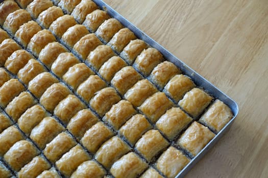 Famous Turkish baklava dessert sliced in a baking tray, Gaziantep baklava,