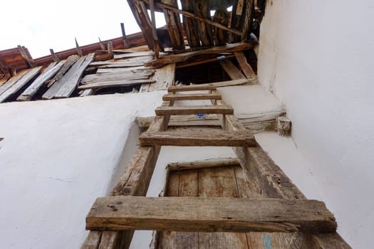 classic handmade wooden ladder for climbing on the roof,