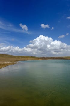 wonderful spring landscape of sky lake and clouds,clouds reflecting in water,