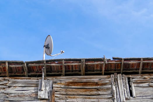 satellite dish on wooden roof, dish antenna installed on the roof,