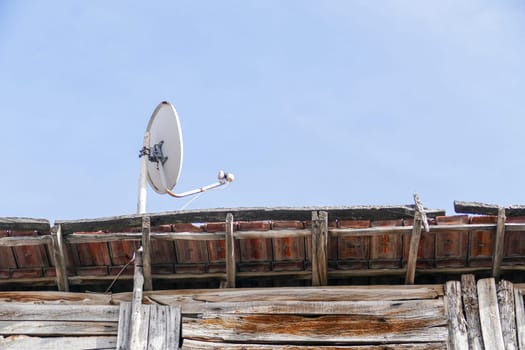 satellite dish on wooden roof, dish antenna installed on the roof,