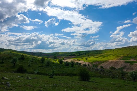 cloudy sky and green landscape, wonderful spring views, green field and hill plateau view,