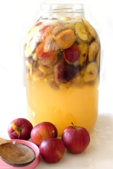 making homemade apple cider vinegar, a large jar of apple cider vinegar, making handmade natural apple cider vinegar,