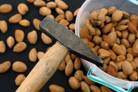 break dry shelled almonds with hammer. hammer and dry almonds,