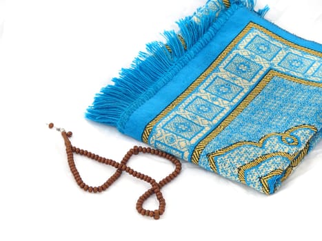 close-up prayer rug and rosary, Islam and prayer rug, on the prostration Muslims pray on,