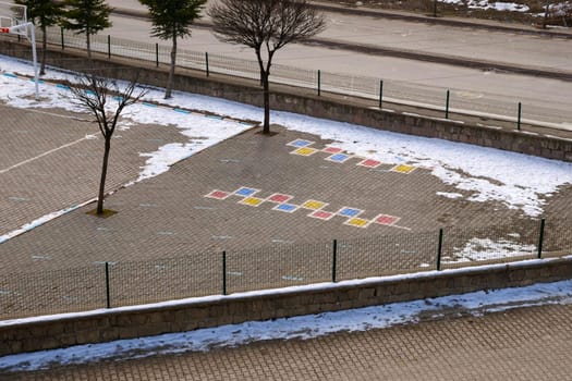 game figures drawn on the floor in a schoolyard,