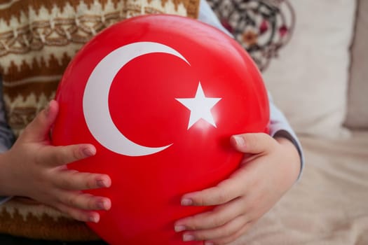 A balloon with a Turkish flag on it, a child holding a balloon with a Turkish flag, a patriotic Turkish child,