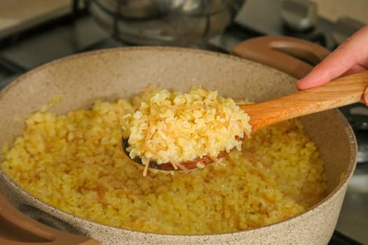 bulgur pilaf cooking on the stove, cooking pilaf, bulgur pilaf cooked in a pot,