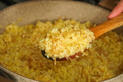 bulgur pilaf cooking on the stove, cooking pilaf, bulgur pilaf cooked in a pot,