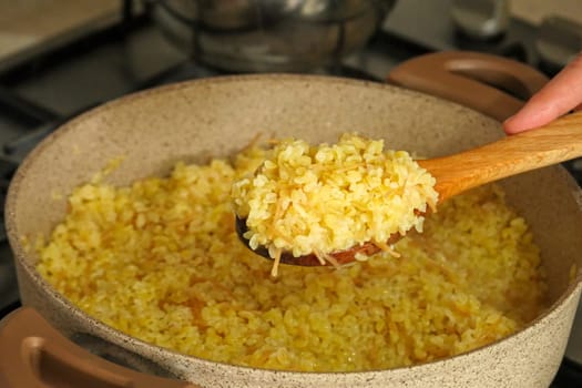 bulgur pilaf cooking on the stove, cooking pilaf, bulgur pilaf cooked in a pot,