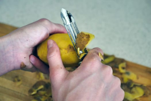 close-up peeling potatoes,person peeling potatoes to prepare a meal, close-up peeled potatoes and unpeeled potatoes,