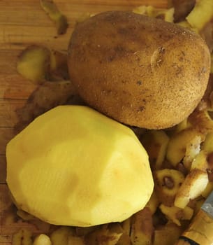 close-up peeling potatoes,person peeling potatoes to prepare a meal, close-up peeled potatoes and unpeeled potatoes,