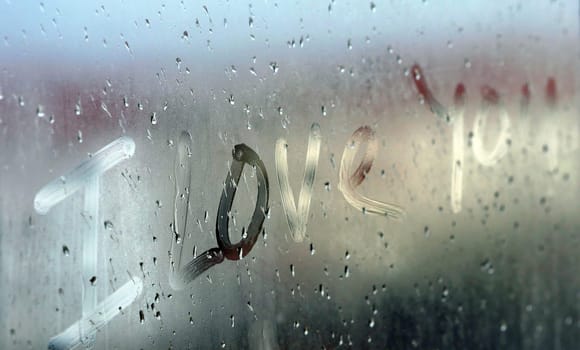 "I love you" written on fogged glass,