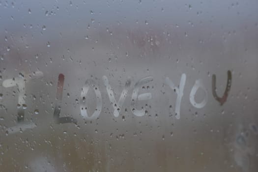 "I love you" written on fogged glass,