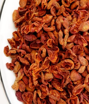 drying apricots in a metal tray on the balcony of the house, drying apricots in the sun, natural fruit drying process,