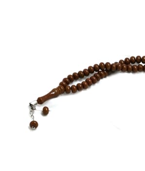 brown prayer rosary in white endless white, close-up rosary, islam and rosary,