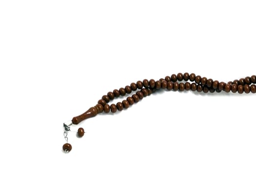 brown prayer rosary in white endless white, close-up rosary, islam and rosary,