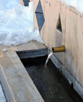 a fountain in the snow, a fountain that flows in winter