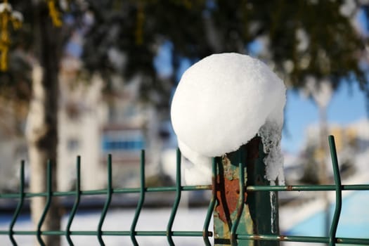 snow cluster accumulating on the garden iron fence,