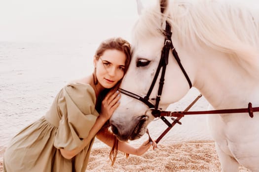 A white horse and a woman in a dress stand on a beach, with the sky and sea creating a picturesque backdrop for the scene