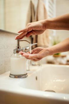 Closeup shot of an unrecognizable woman washing her hands with soap to prevent Coronavirus.