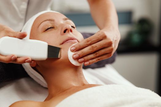 Shot of a beautiful mature woman on a ultrasonic facial treatment at the beauty salon.