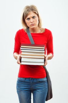 Portrait of angry female student holding books.