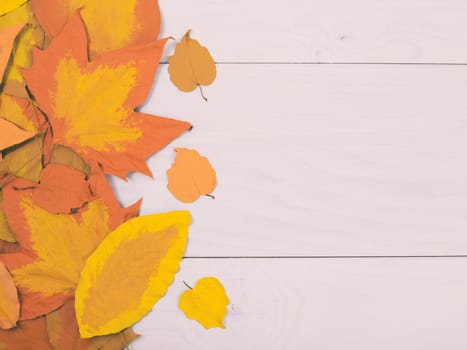 Image of wooden table and painted leaves.Tone image.
