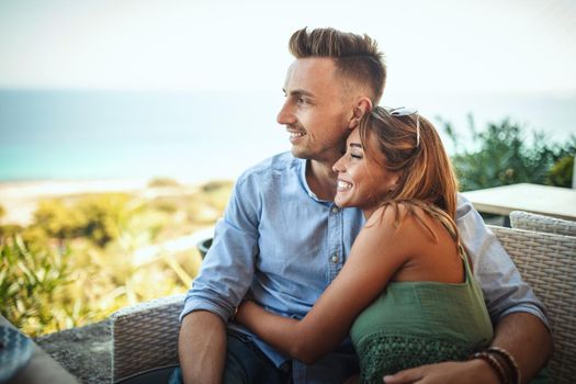 A beautiful young couple is having fun while spending time in a Mediterranean town. They are enjoying in summer sunny day,