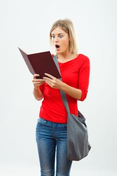 Image of surprised female  student reading a book.