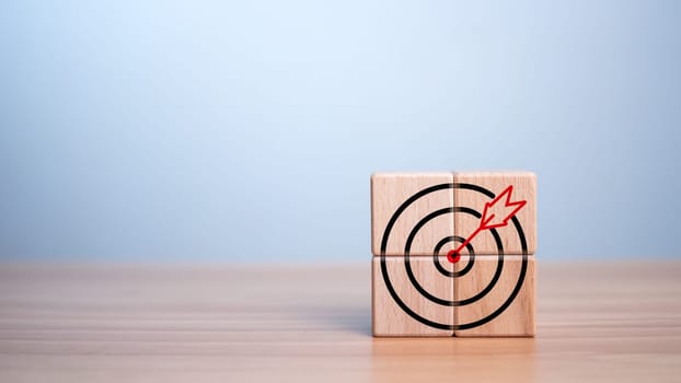 Wooden block and target icon placed on wooden background. Business concept. Management concept. Business planning concept.