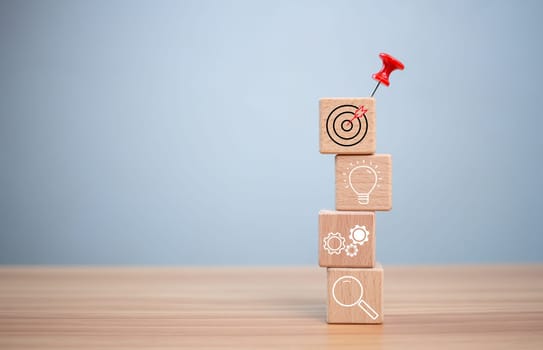 Red push pin to target and success on wooden block. Startup concept. Business concept. Management concept. Business planning concept.