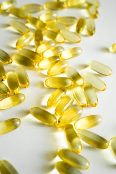 Gelatin capsules of omega 3, 6, 9 fish oil, vitamin isolated on a white surface as a background