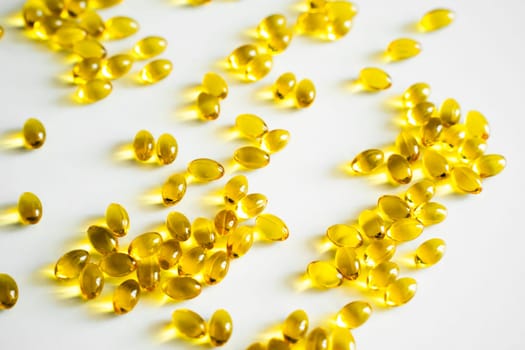 Oil filled capsules, softgel of food supplements. Vitamin D3. Yellow softgels, top view, copy space. Nutritional supplements