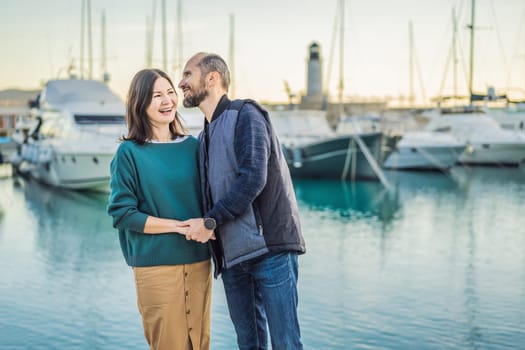 Couple in love tourists enjoying the views of Architecture and luxury yachts in Lustica Bay, Montenegro. Travel around Montenegro concept. Go Everywhere.