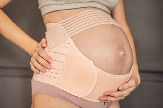 A pregnant woman feeling secure and supported, wearing a bandage designed for pregnancy to provide gentle support and comfort.