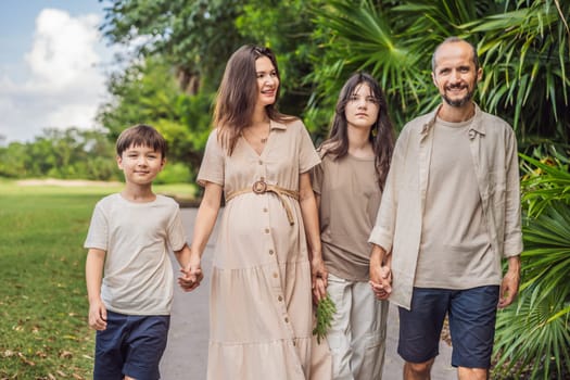 A loving family enjoying a leisurely walk in the park - a radiant pregnant woman after 40, embraced by her husband, and accompanied by their adult teenage children, savoring precious moments together amidst nature's beauty. Pregnancy after 40 concept.