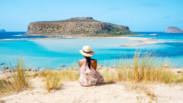 Crete Greece, Balos lagoon on Crete island, Greece. Tourists relax at the crystal clear ocean of Balos Beach. Greece, a Asian woman visit the beach during a vacation in Greece