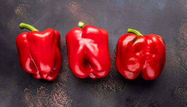 Sweet red and yellow peppers, whole top view dark background, with space to copy text.