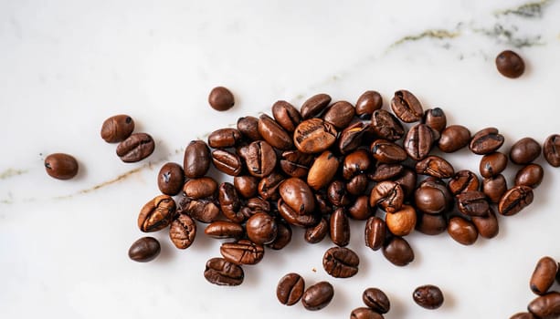 Coffee beans are spilled on a wooden table. Coffee Cup on the turquoise table. Still life with coffee.