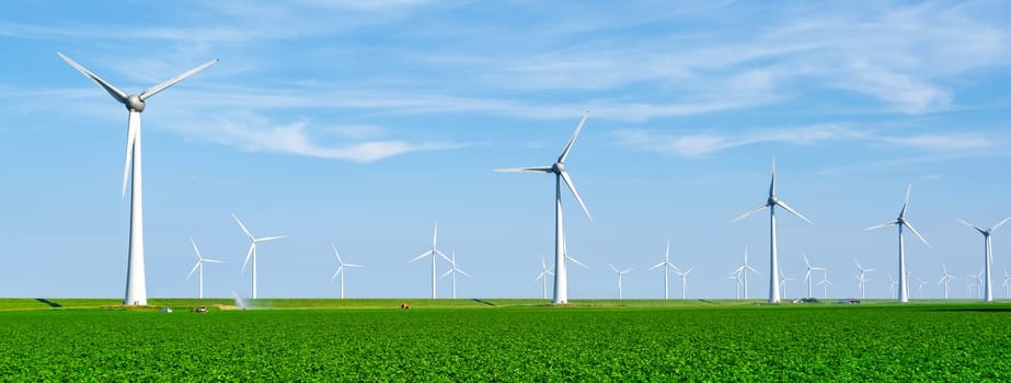 Windmill park with clouds and a blue sky, windmill park in the ocean aerial view with wind turbine Flevoland Netherlands Ijsselmeer. Green Energy production in the Netherlands