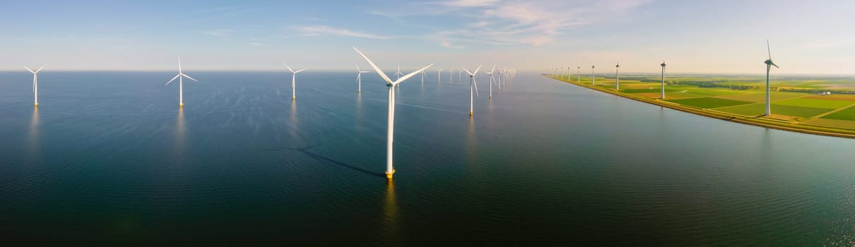 Wndmill park in the ocean aerial view with wind turbine Flevoland Netherlands Ijsselmeer. Green Energy in the Netherlands on a sunny day
