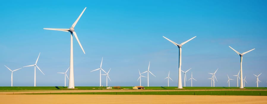 Windmill park with clouds and a blue sky, windmill park in the ocean drone aerial view with wind turbine Flevoland Netherlands Ijsselmeer. Green Energy in the Netherlands