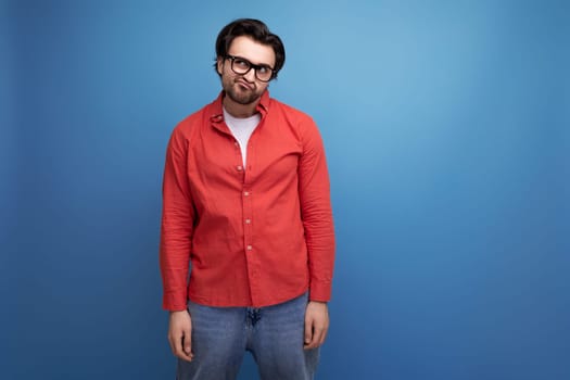 attractive 35 year old brunette millennial man with gorgeous hair in a red shirt.