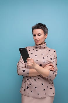 pretty 30 year old european business woman with dyed gray short hair in a skirt and blouse texting on the phone.