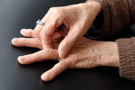 elderly woman's hand with a ring on her finger, old woman's hand and fingers,