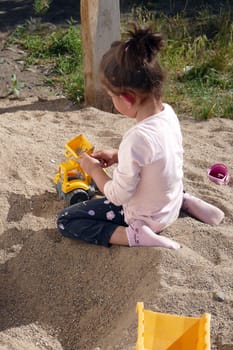 children playing in the sand, happy children playing in the sand in the garden,